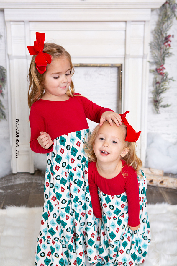 Close up of sisters playing during Christmas photos in Vero Beach Florida