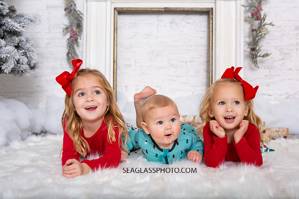 Siblings lay on their bellies for Christmas photos in Vero Beach Florida