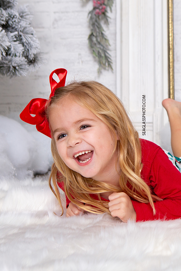 Young girl laughs for Christmas photos in Vero Beach Florida
