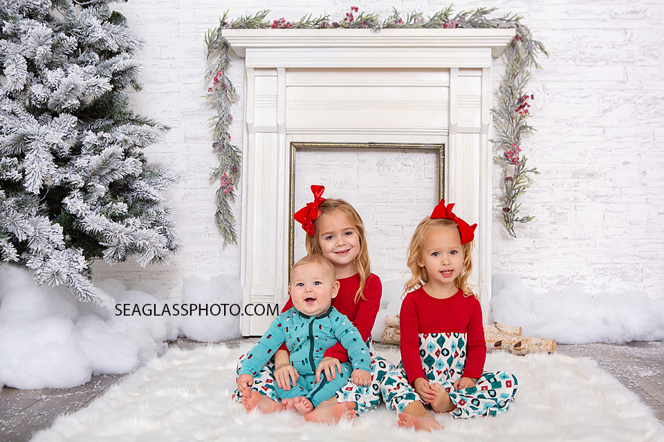 Siblings smile for a picture during their Christmas photoshoot in Vero Beach Florida