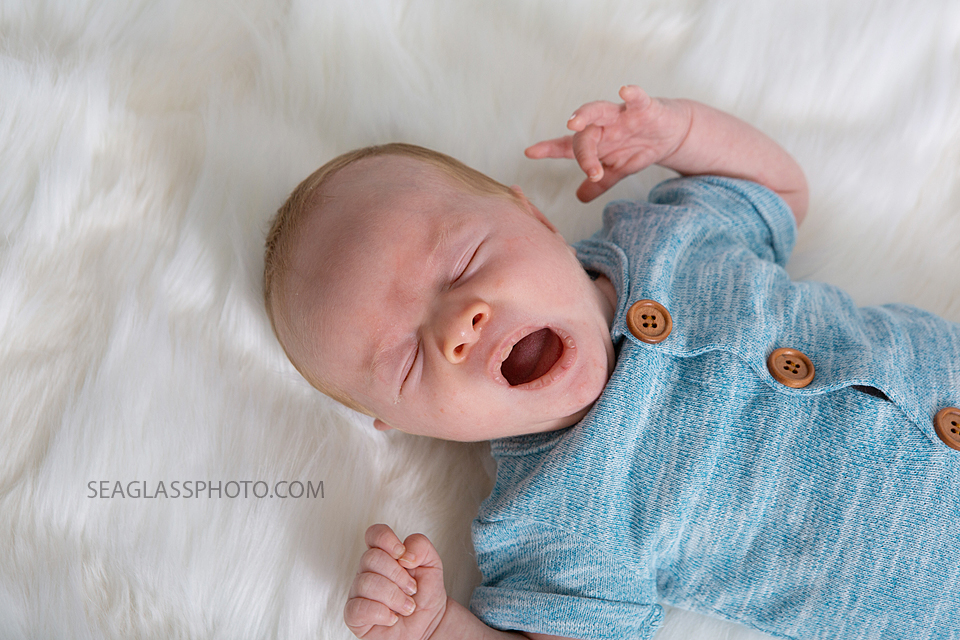 Close up of newborn baby boy yawning during newborn photoshoot in Vero beach Florida