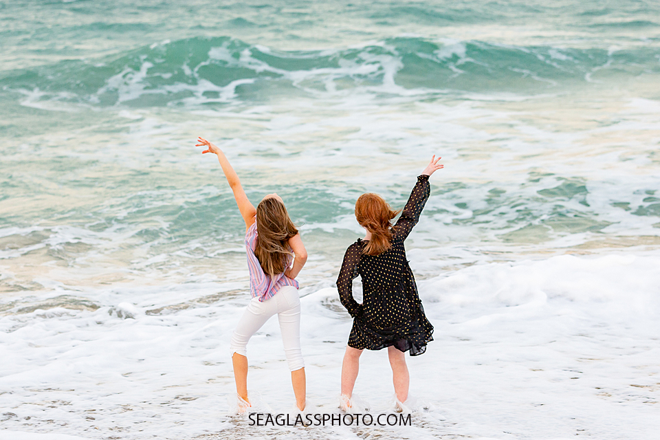 Cousins pose for a cute picture in front of the ocean during family photos in Vero Beach Florida