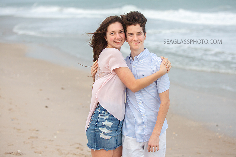 Siblings hug on the beach during family photoshoot in Vero Beach Florida