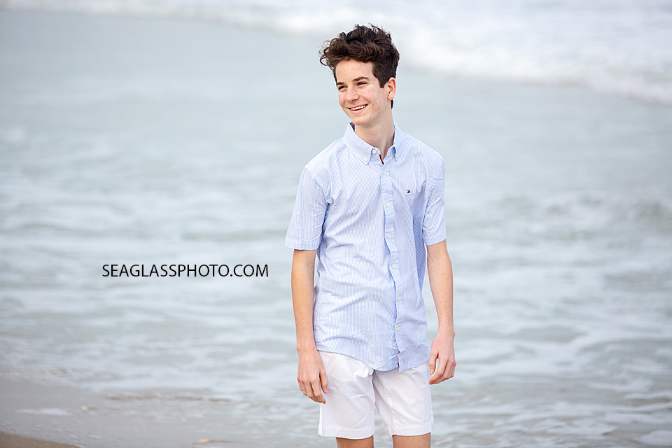 Close up of young man walking during family photoshoot on the beach in Vero Beach Florida