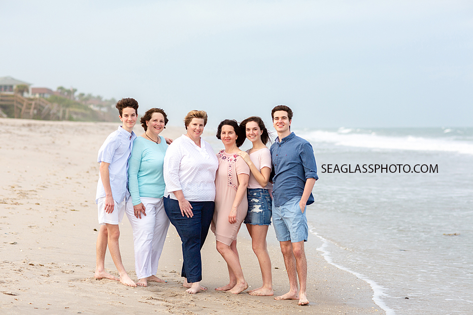 Family hugs together during family photoshoot on the beach in Vero Beach Florida