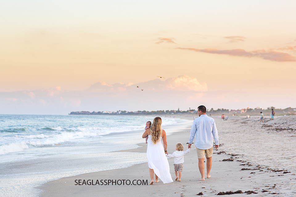 Family walks on the beach during their family photoshoot in Vero Beach Florida