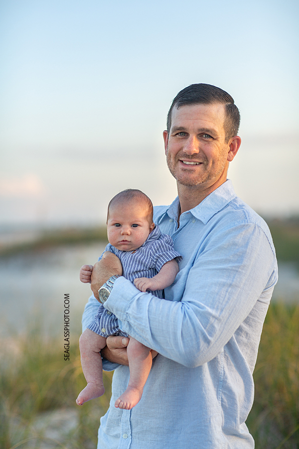 Father with his two month old son on the beach during their family photoshoot in Vero Beach Florida