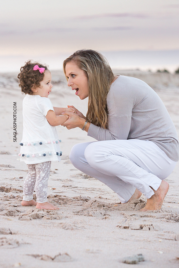 Mom and daughter have a heart to heart on the beach during their family photo shoot in Vero Beach Florida