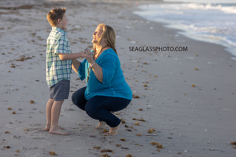 Mom and son laughing together during a family photoshoot in Vero Beach Florida
