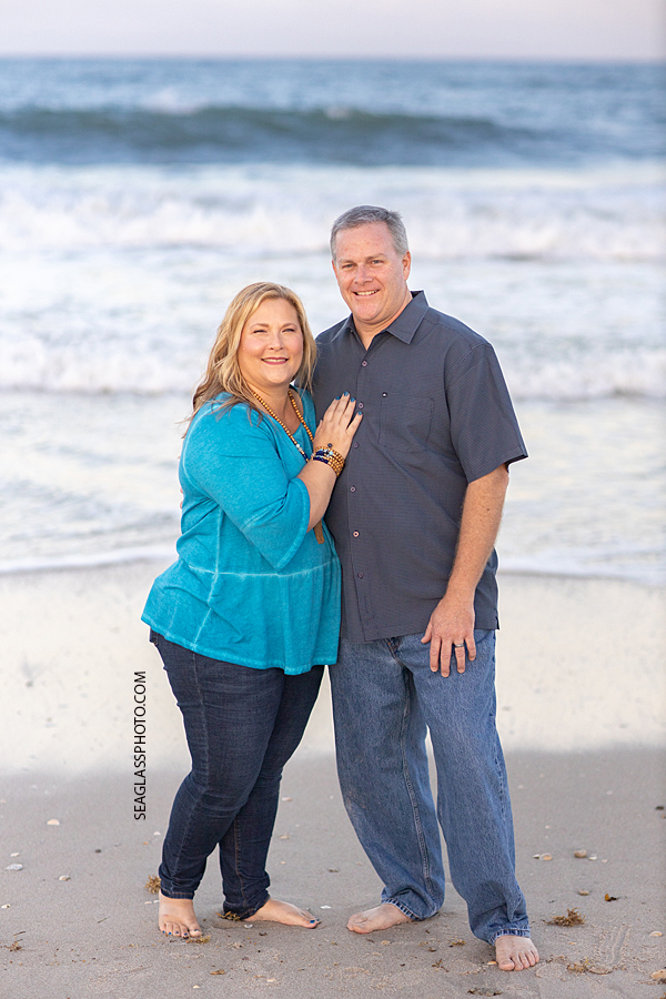 Father and mom smile for the camera during a family photoshoot in Vero Beach Florida