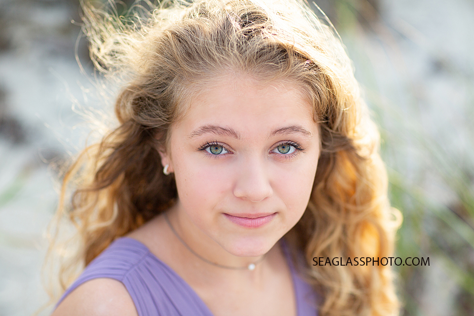 Close up of a young senior posing for her senior photos in Vero Beach Florida