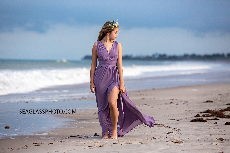 Senior posing on the beach during her senior photoshoot in Vero Beach Florida