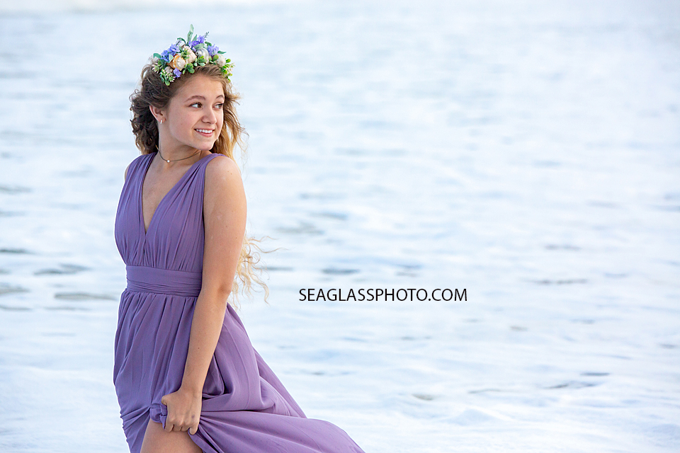 Senior looks over the ocean during her senior photoshoot in Vero Beach Florida