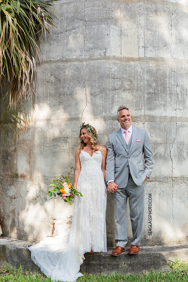 Bride and Groom standing together smiling and laughing after they got married in Vero Beach Florida