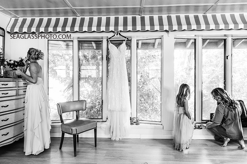 Black and White Wedding Dress hanging while the wedding party gets ready in Vero Beach Florida
