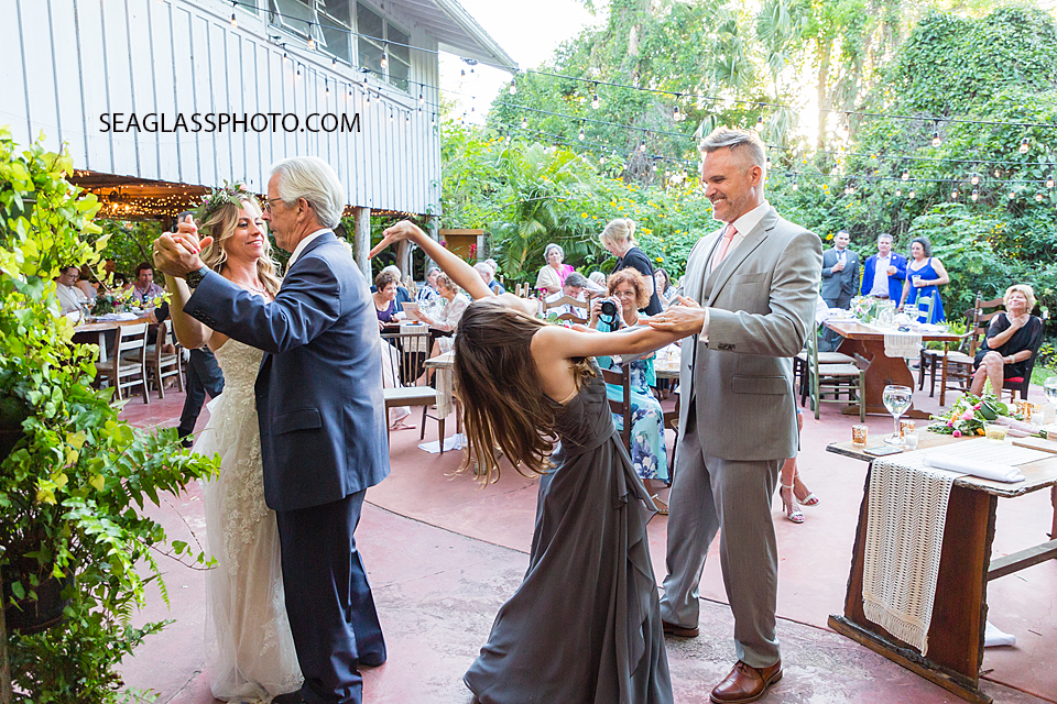 Bride and her father and Groom and his daughter dancing together at the wedding reception in Vero Beach Florida
