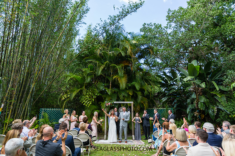 Wedding guests cheer for the newly married couple after the ceremony is completed in Vero Beach Florida