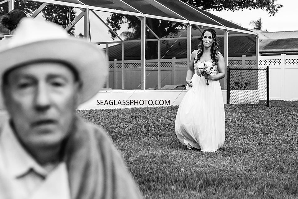 Black and White Bride looking towards her father as she walks up to her wedding in Vero Beach Florida