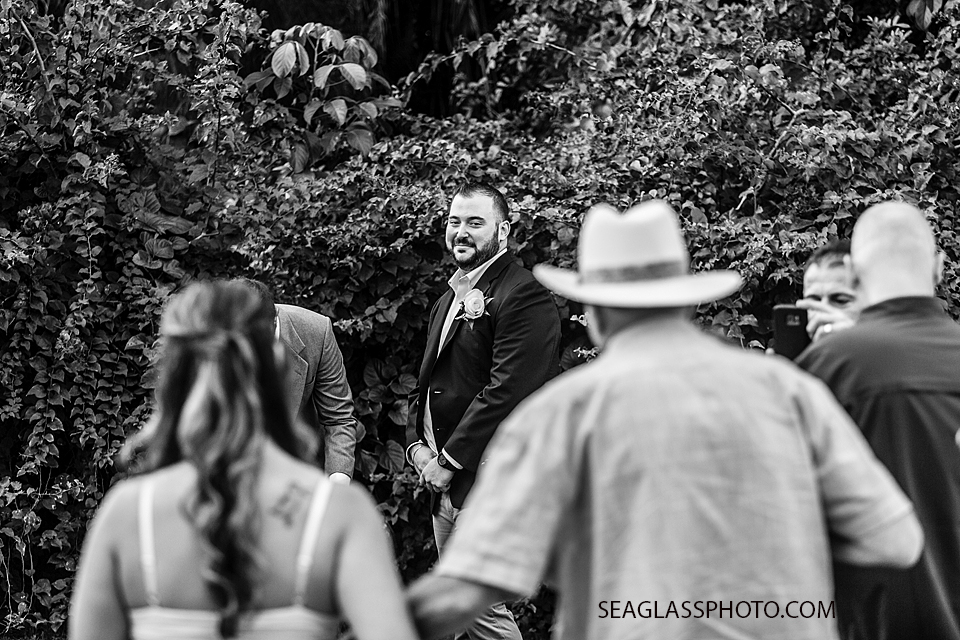 Black and White Groom watches as his Bride and her father walk up the aisle towards him in Vero Beach Florida