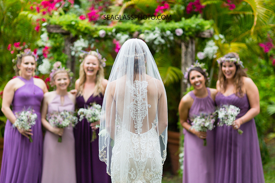 The Bride looks to her bridesmaids as they smile in excitement in Vero Beach Florida