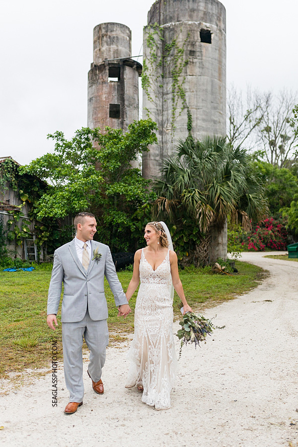 Bride and Groom walking and smiling at each other after their wedding ceremony in Vero Beach Florida