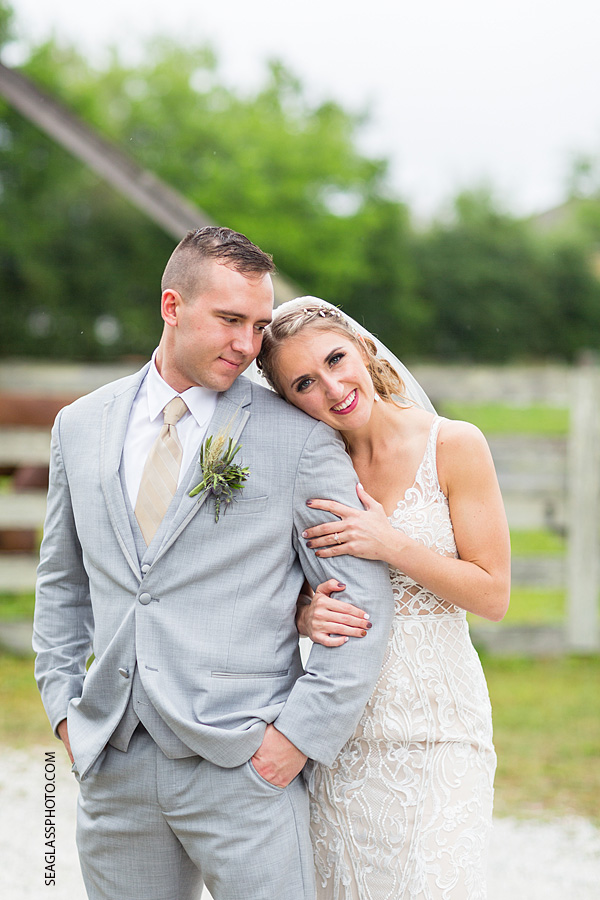 Groom looks at his Bride as she hugs and smiles for the camera in Vero Beach Florida