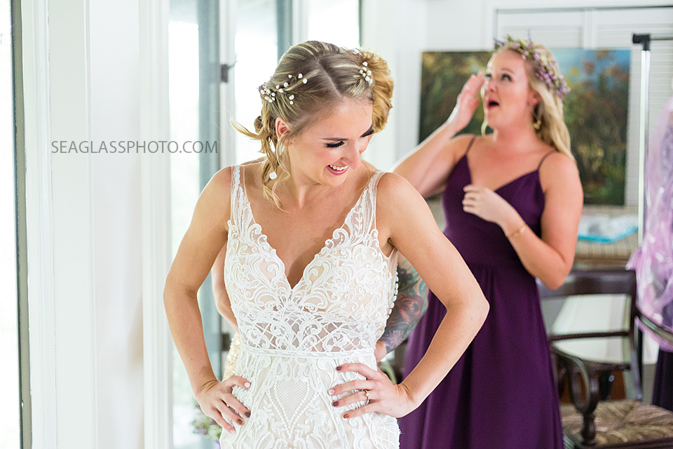 The brides mom helps zip up her dress before the wedding in Vero Beach Florida