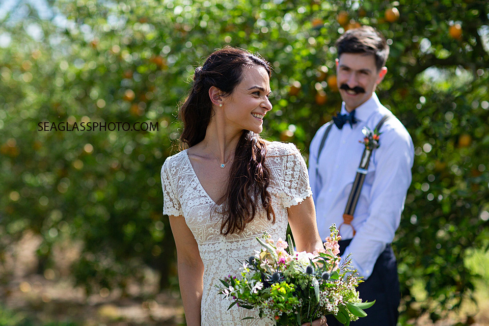 Bride looks back at her soon to be husband on their big day in Vero Beach Florida