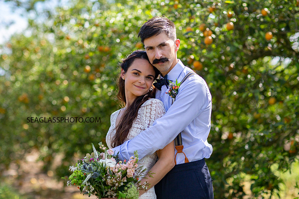 Bride and Groom in an orange grove on their big day in Vero Beach Florida