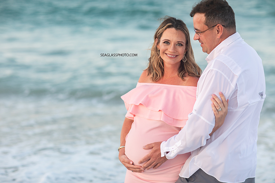 Parents connecting with their unborn baby on the beach at sunset in Vero Beach Florida