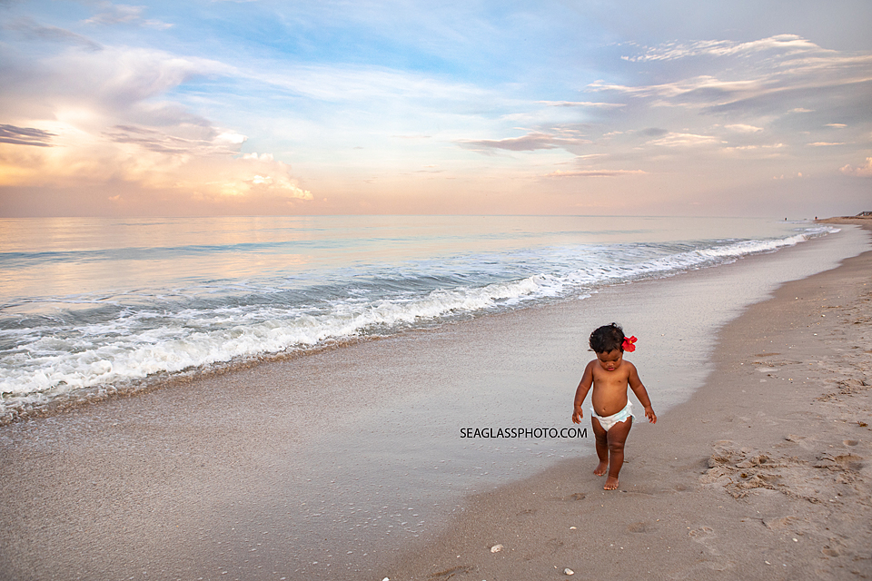 Little girl walking down the beach in Vero Beach Florida