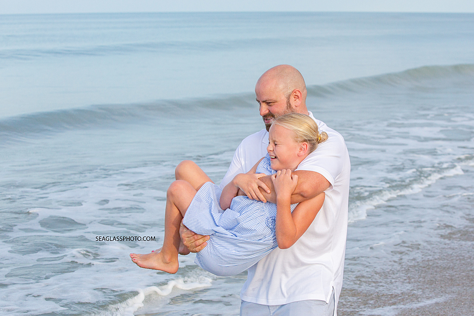 Father and daughter playing on the beach in Vero Beach Florida