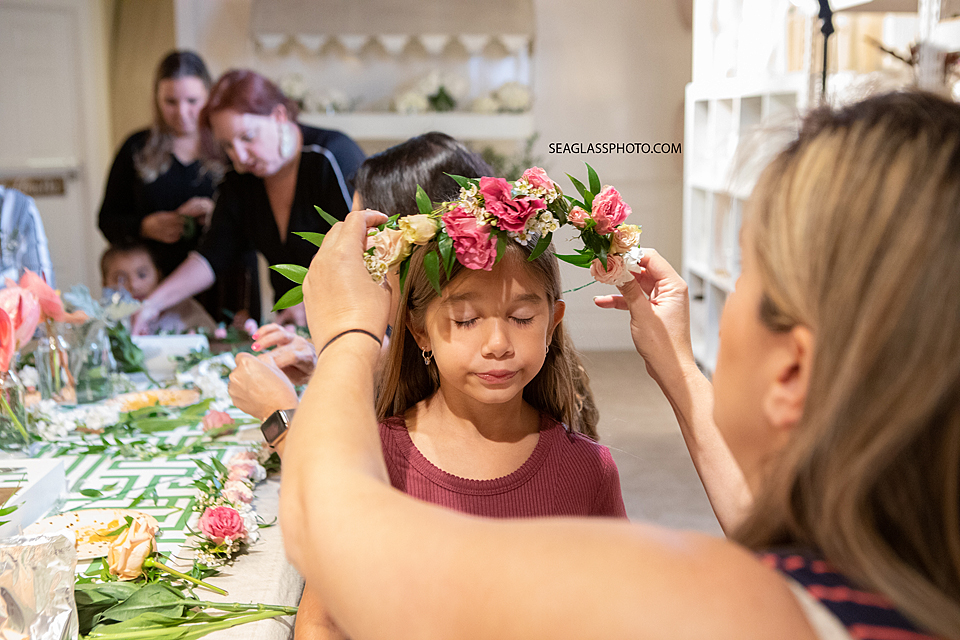 Mother placing flower crown on daughters head in Vero Beach Florida