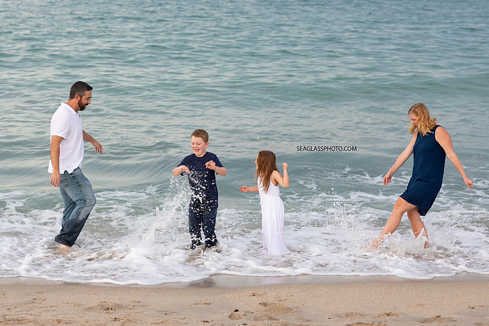 Family playing in the water on the beach in Vero Beach Florida