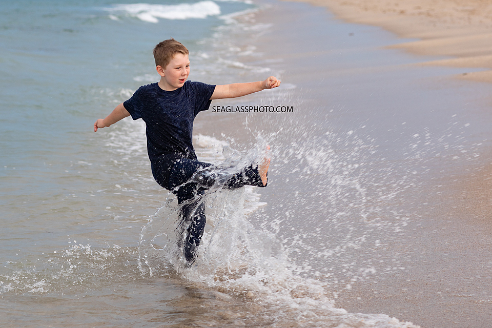 Boy playing in the water on the beach in Vero Beach Florida