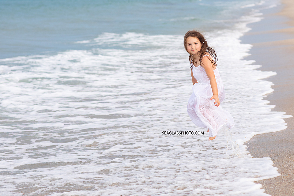 Girl playing in the water on the beach in Vero Beach Florida