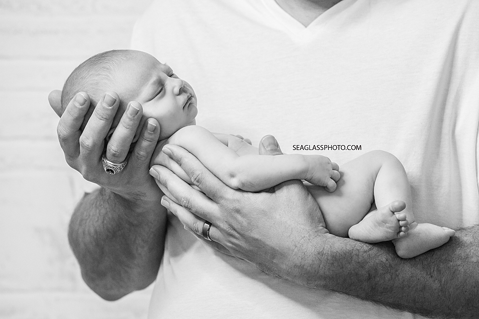 Newborn girl being held by her father in Vero Beach Florida