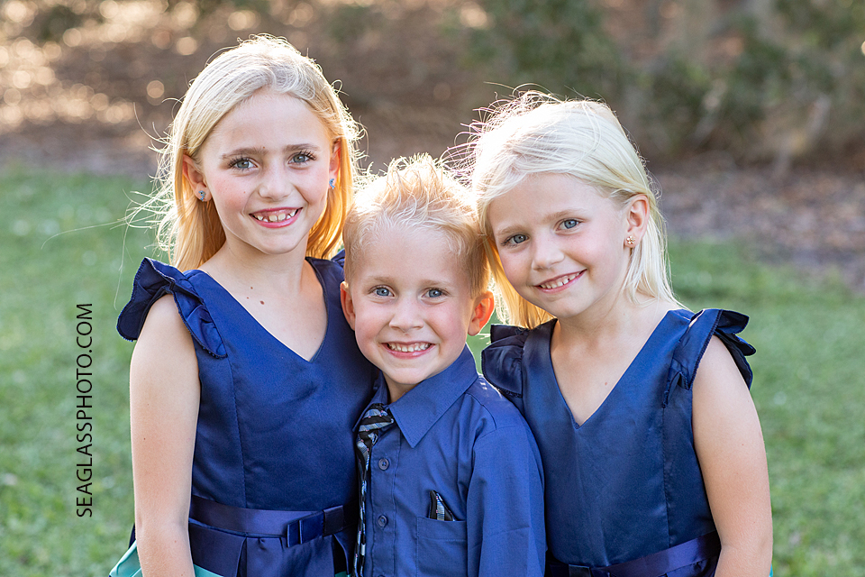 colorful sibling photo fun family photo wearing blue dress at Riverside park in Vero Beach Florida by Seaglass Photography