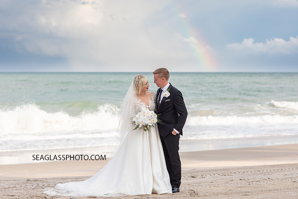 bride and groom with rainbow on the beach Wedding-CostadEste-Disney-Family-Vero-Beach-Photographer-Windsor-