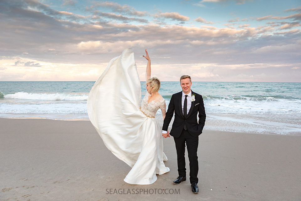 bride and groom playing in the wind on the beach at sunset Wedding-CostadEste-Disney-Family-Vero-Beach-Photographer-Windsor-Seaglass-