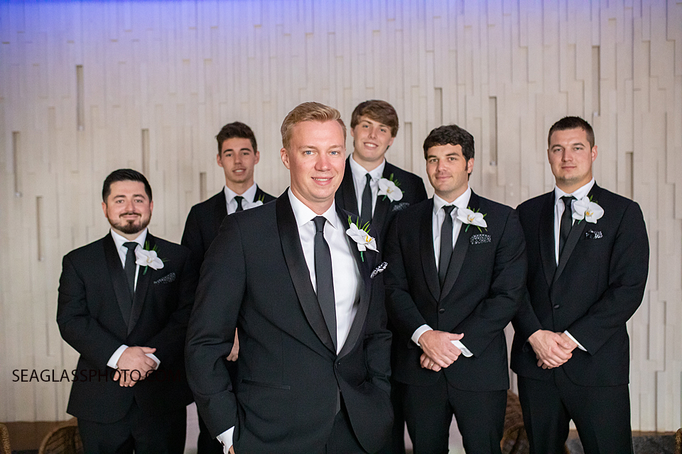 groom and groomsmen standing infront of a white wall Wedding-CostadEste-Disney-Family-Vero-Beach-Photographer-Windsor