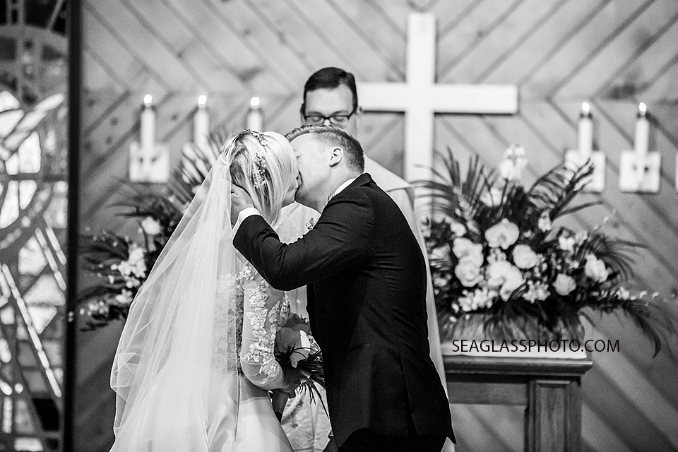 black and white photo of bride and grooms first kiss Wedding-CostadEste-Disney-Family-Vero-Beach-Photographer-Windsor