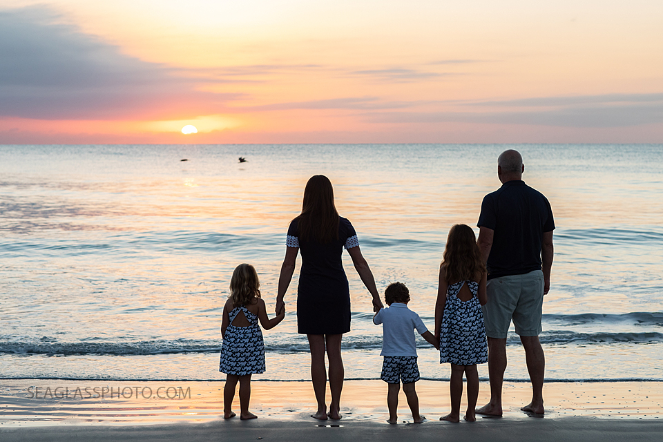 vero beach family at sunrise on the beach with birds flying