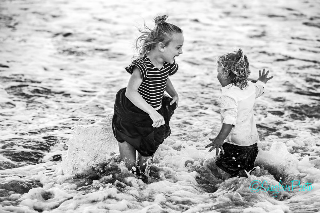black and white photo of kids playing in water Vero Beach Florida Newborn Photographer