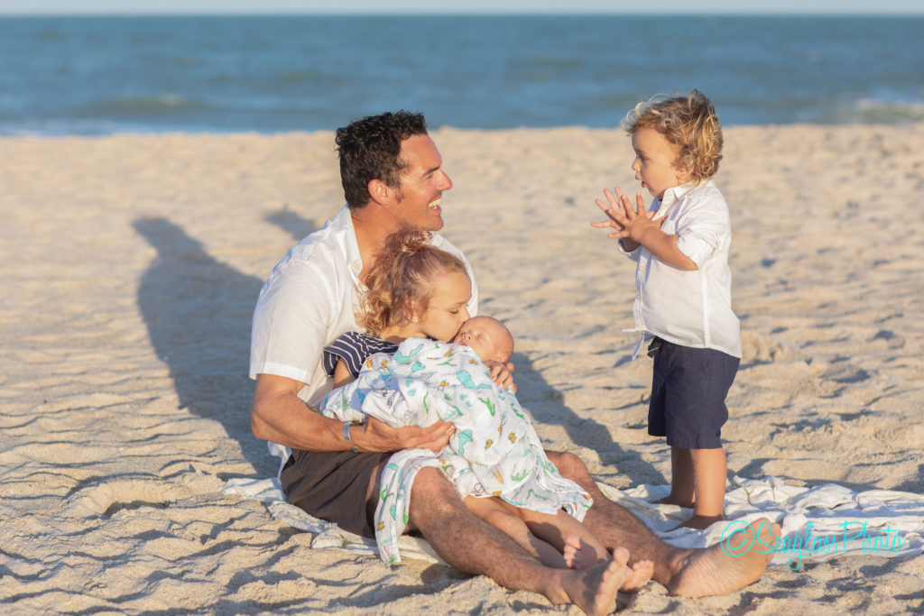 father with children and neborn on the beach Vero Beach Florida Newborn Photographer