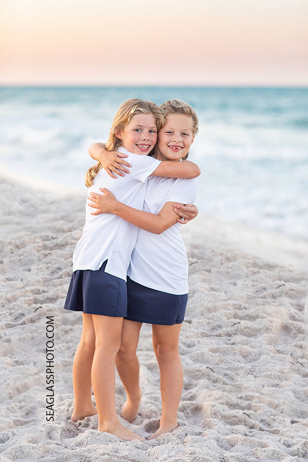 Sisters Vero Beach Family portrait on the beach at sunset wearing navy and white 32963