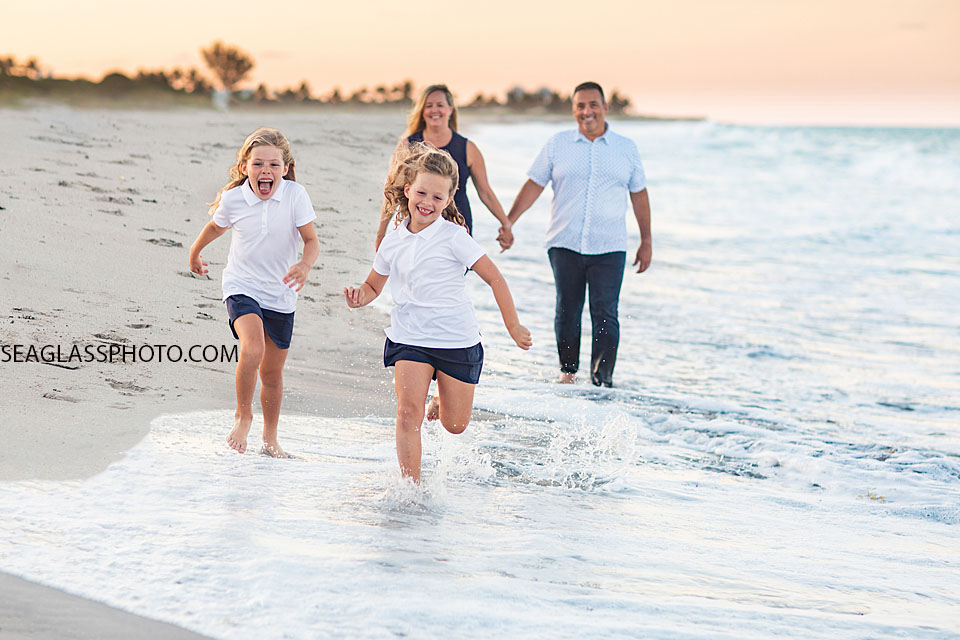 Vero Beach Family running on the beach at sunset wearing navy and white 32963