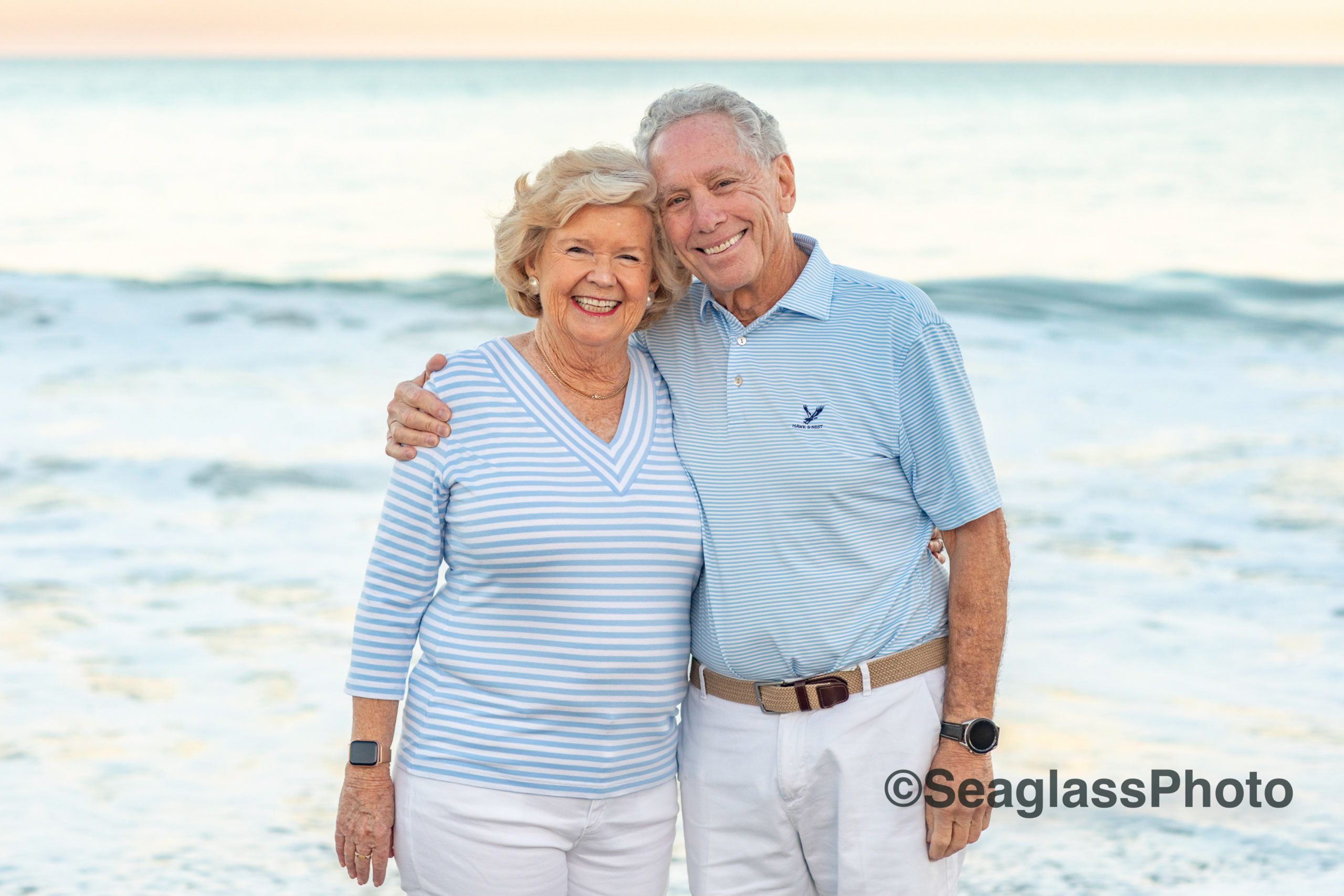 an elderly husband and wife smiling on the beach at sunset in Vero Beach Florida