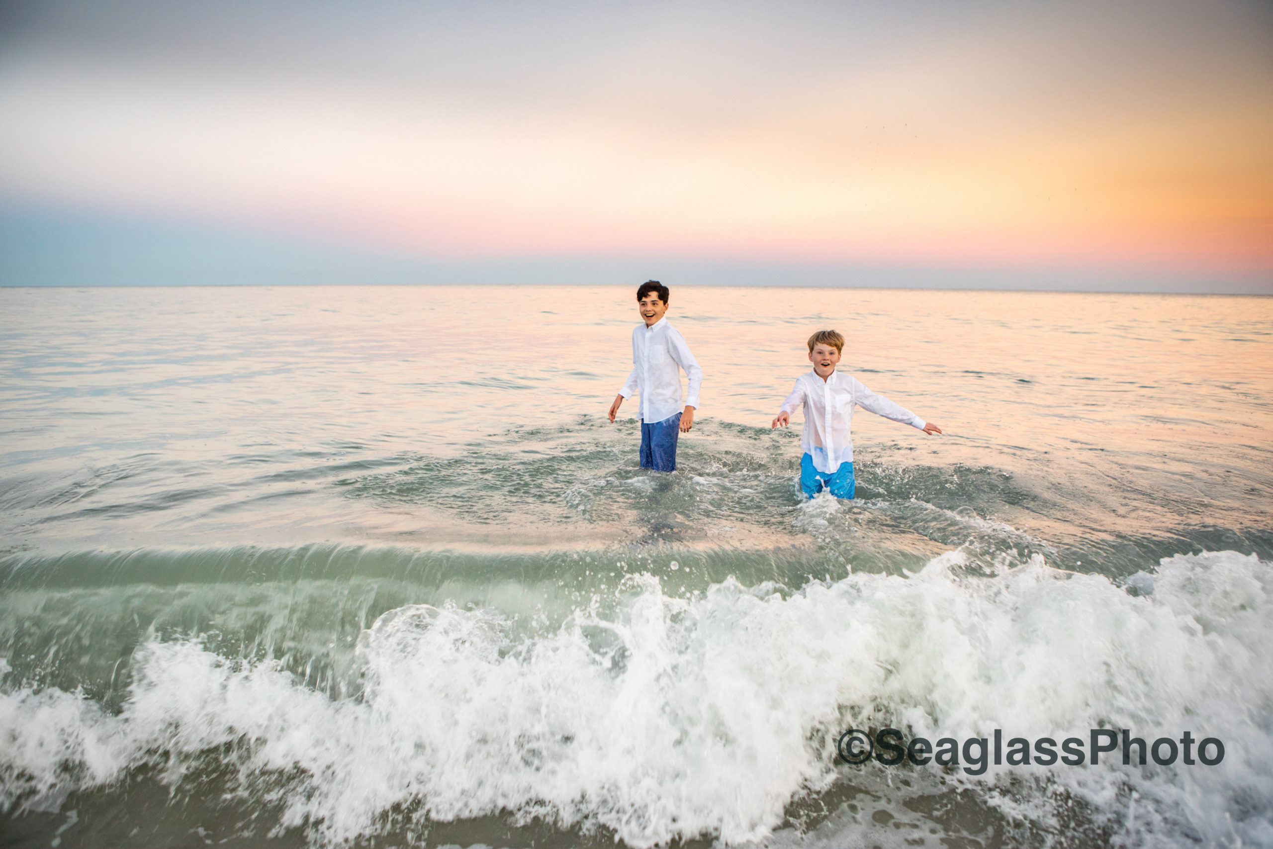 brothers playing in the ocean at sunset at Windsor Beach Club in Vero Beach Florida