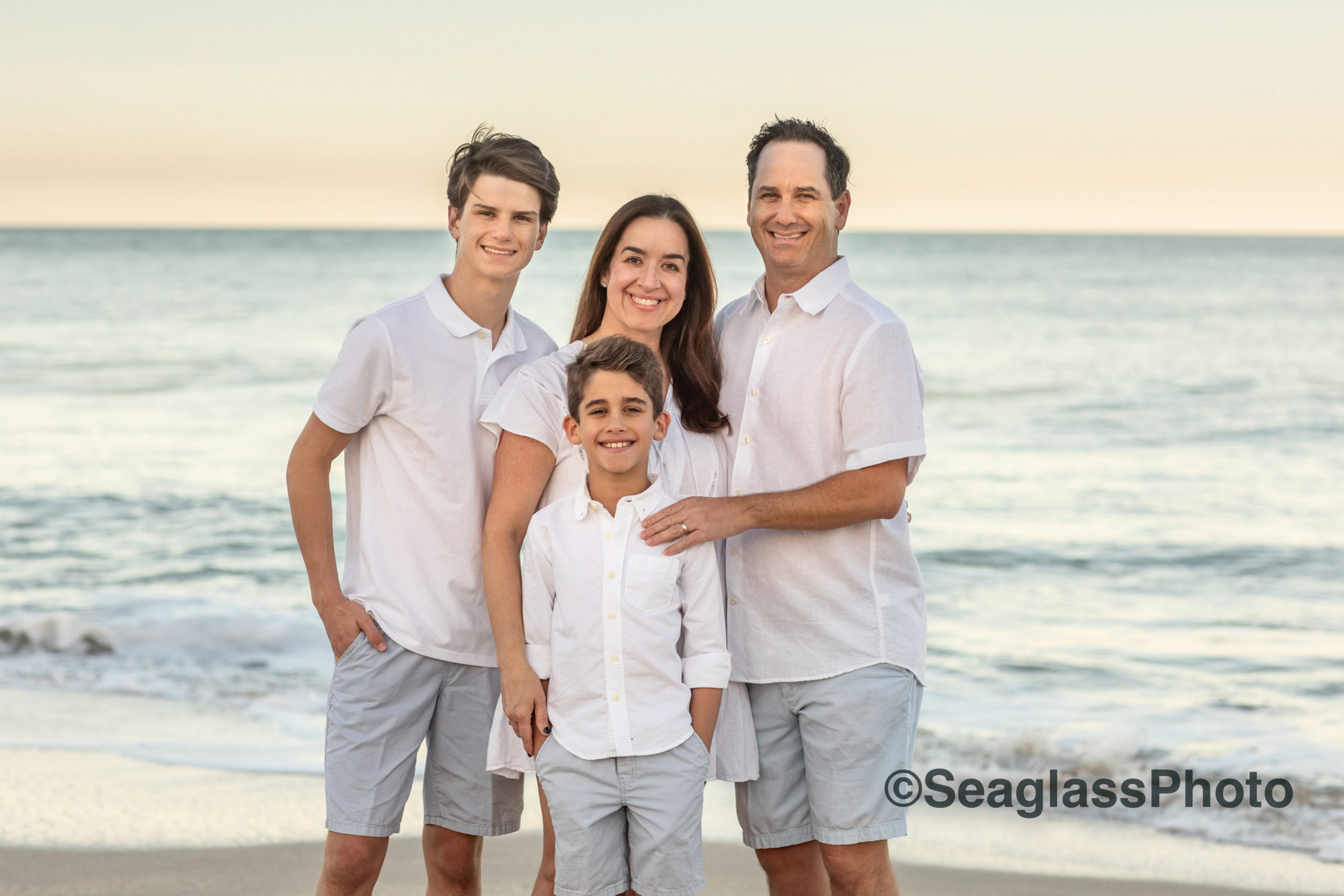 portrait of family with the ocean in the background